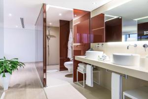 a bathroom with two sinks and a toilet at NH Collection Mexico City Reforma in Mexico City