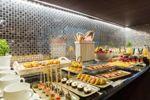 a buffet line with many different types of food at NH Collection Mexico City Reforma in Mexico City