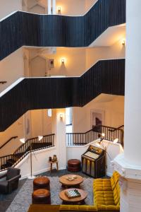 a living room with a couch and a staircase at Le Val Thorens, a Beaumier hotel in Val Thorens