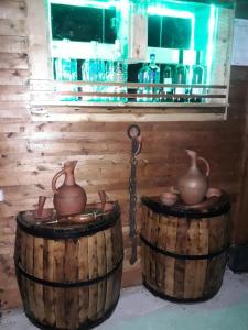 two wooden barrels with vases on top of them at Cozy home in Zugdidi