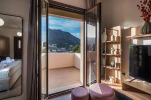 a room with a balcony with a view of a bedroom at Archanes Luxury Apartment in Archanes