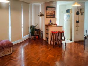 a kitchen with a refrigerator and two bar stools at Las Tejas in Córdoba