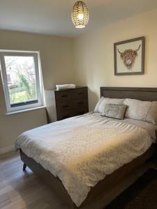 a bedroom with a large bed and a window at 15 Waterwheel Wharf, Annalong in Newry