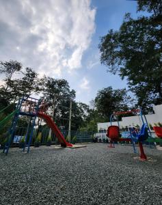 a playground with two slides and a swing set at Wayanad Palace in Ambalavayal
