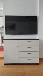 a white entertainment center with a tv on top of it at Appartement Twin Peak Edelweiss in Gosau