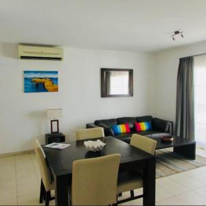 a living room with a table and a couch at Tranquil Apartment at Tortuga Beach - 221 in Prainha