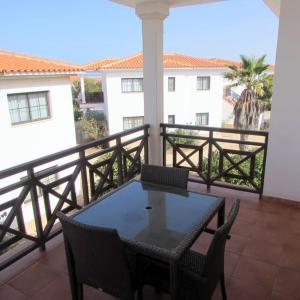 a balcony with a table and chairs on a balcony at Tranquil Apartment at Tortuga Beach - 221 in Prainha
