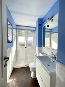 a bathroom with a toilet and a shower and a sink at Hispalis Ático Bermejales in Seville