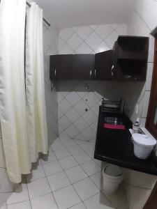 a bathroom with a toilet and a sink and a shower at Apartamento inteiro( 1° andar) - Guarabira/PB in Guarabira