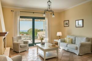 a living room with a couch and a table at Villa Petri in Trapezaki