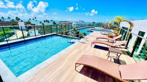 a swimming pool on top of a building at "Vivendo no Paraíso" - Flat C/Suíte no Centro in Porto De Galinhas