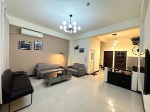 a living room with two couches and a table at Sister Hong's home in Jincheng