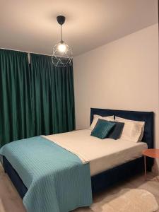 a bedroom with a bed with a green curtain at Premium HILS Pallady in Bucharest