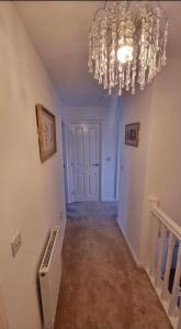 an empty hallway with a chandelier in a house at Penton place in Catterall