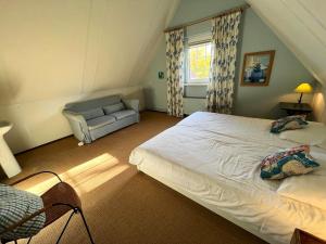 Ένα ή περισσότερα κρεβάτια σε δωμάτιο στο Vakantiewoning Westhoek