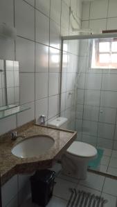 a bathroom with a sink and a toilet and a mirror at Casa próximo a Guaramiranga in Guaramiranga