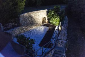 an overhead view of a swimming pool at night at Hotel La Masía in Pont de Molíns