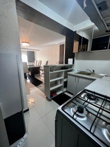 a kitchen with a stove top oven in a room at Apartament zona fabricii Ford in Craiova