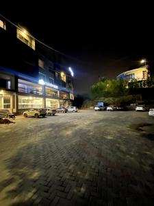 a parking lot in front of a building at night at French 2-bed in Rawalpindi