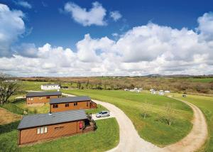 an overhead view of a barn with a car parked next to it at Meadow Lakes Holiday Park in St Austell