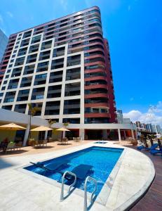 a large building with a swimming pool in front of a building at Iate Plaza Hotel in Fortaleza