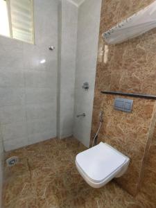 a bathroom with a toilet and a shower in it at Hotel Zain Grande in Chennai