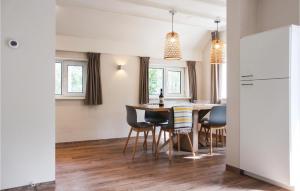 a kitchen and dining room with a table and chairs at Houtsnip in Ommen