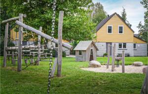 a playground with a slide in a yard with a house at Beautiful Home In Wemeldinge With Wifi in Wemeldinge