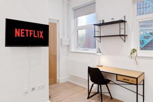 a office with a desk and a sign on a wall at The Market Street Studios in Nottingham