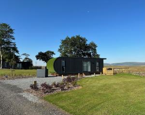 a black tiny house with a green dome at Green Law - Dog Friendly in Penicuik