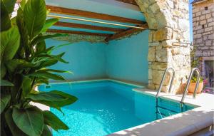 a swimming pool in a house with at Cozy Home In Donje Selo With Kitchen in Donje Selo na Šolti