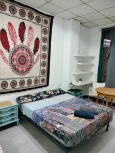 a bed in a room with a rug on the wall at KALIFORNIA CENTRAL in Alicante