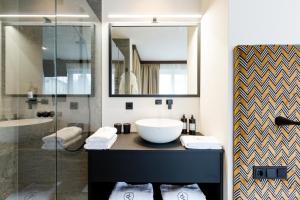 a bathroom with a sink and a glass shower at Dorfchalet in Grossarl +113 photos