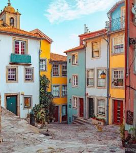 a group of colorful buildings in a street at Historical Porto Apartment in Porto