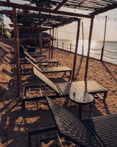 a group of chairs and tables on a beach at Departamento en Manta Edificio Poseidon in Manta