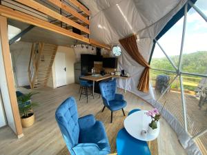 een kamer met een tafel en stoelen in een tent bij Glamping Dôme - Dôme du Rocher rouge in Durban-Corbières