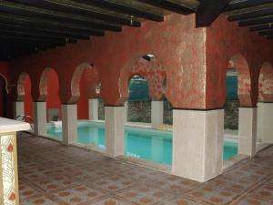 a large swimming pool in a building with arches at Antaviana Cantabria in Cabezón de la Sal