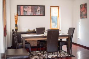 a dining room with a table and chairs at VILLA KYRA LUXURY in Sinaia