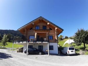 a house with two cars parked in front of it at Haus Ströhle in Schruns