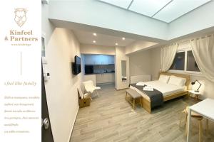 a hotel room with a bed and a dining room at Design downtown suite (K2) in Larisa