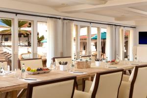 a dining room with a long wooden table and chairs at Kona Kai Resort & Spa, a Noble House Resort in San Diego +32 photos