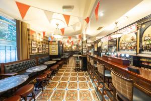 a bar with tables and chairs in a room at Blarney Castle Hotel in Blarney