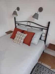 Schlafzimmer mit einem schwarzen und weißen Bett mit Kissen in der Unterkunft Studio privé avec terrasse entrée indépendante in Saint-Nazaire