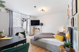 a bedroom with a bed and a dining room with a table at ANYTIME - Apartments in Langenargen in Langenargen