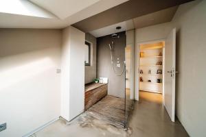 a bathroom with a walk in shower and a glass door at Amazing Apartment in Prague