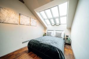 a bedroom with a bed and a skylight at Amazing Apartment in Prague