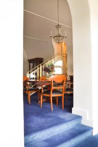 a dining room with a table and chairs at Grand Hotel Saltsj&ouml;baden in Saltsj&ouml;baden