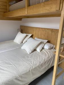 a bedroom with two bunk beds with white pillows at A 25 m. del Telecabina de Pal in La Massana