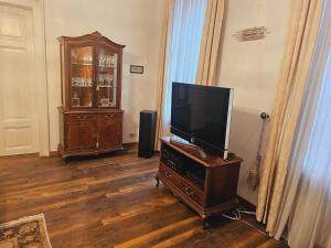 - un salon avec une télévision sur une commode en bois avec une commode dans l'établissement Alan's Downtown Apartment, à Zagreb