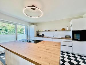 a kitchen with white cabinets and a wooden counter top at Ferienhaus "Eenhoorn" in Dierhagen